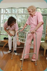 A caregiver helping a client with a walker